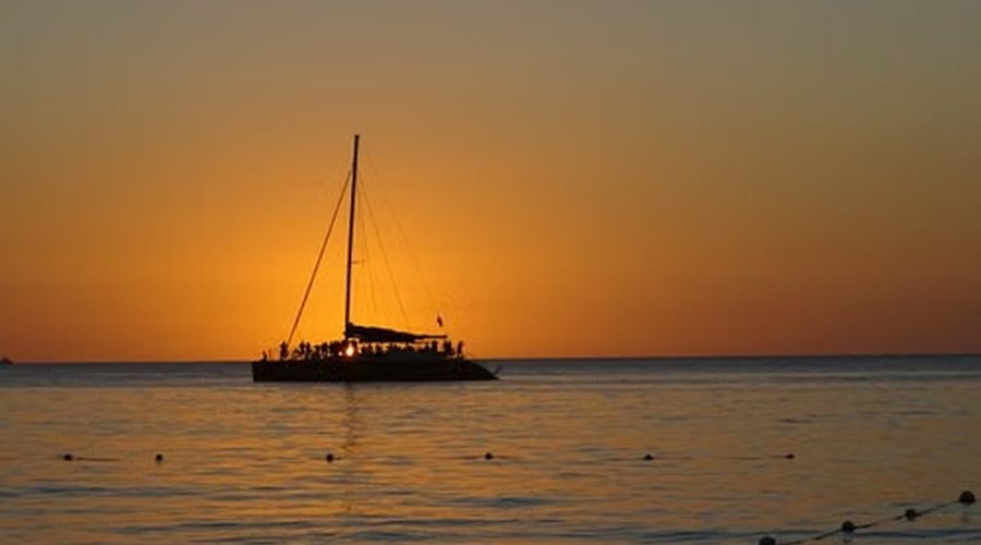 A catamaran at sunset off the north coast