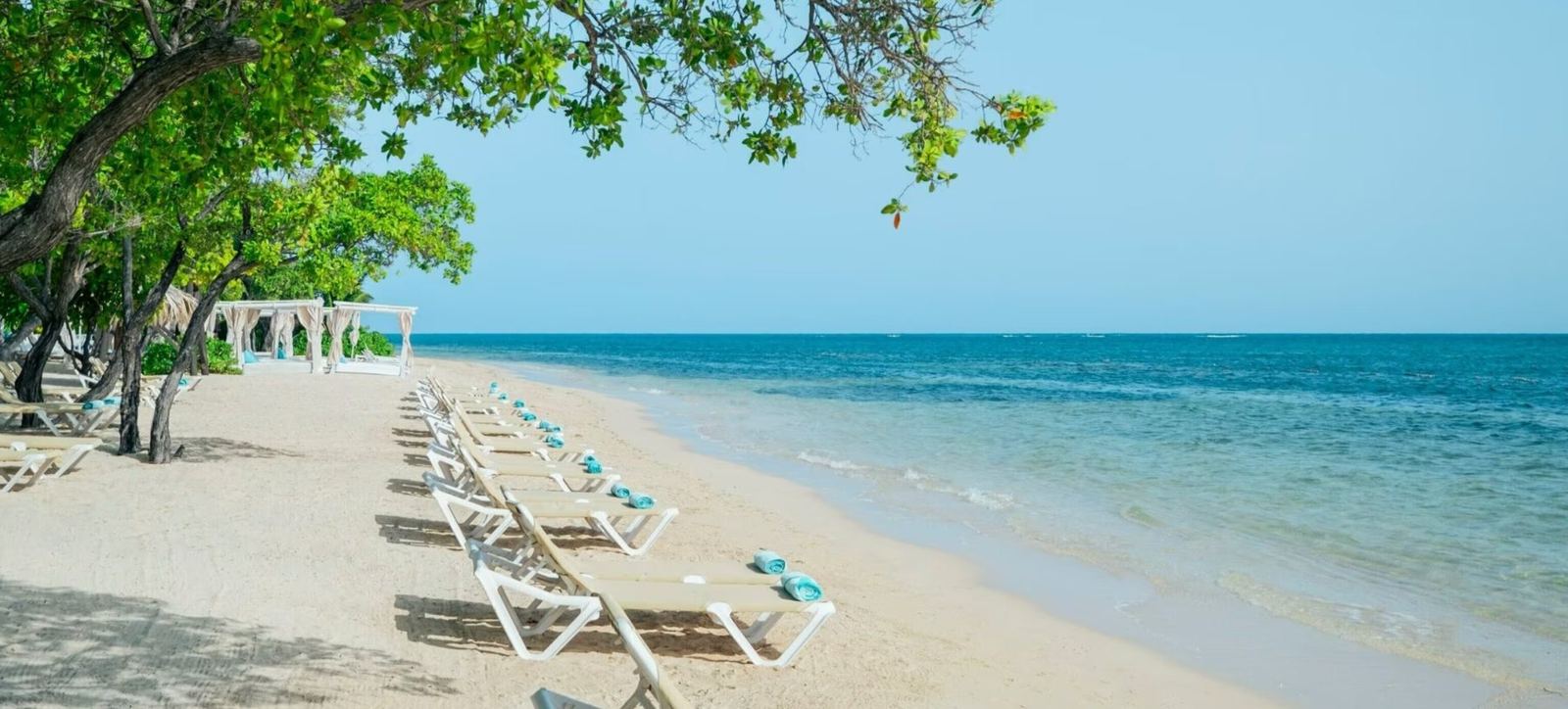 Loungers on the beach at Iberostar Waves Rose Hall