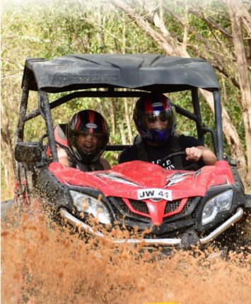 A buggy splashing through the mud on a JamWest trail