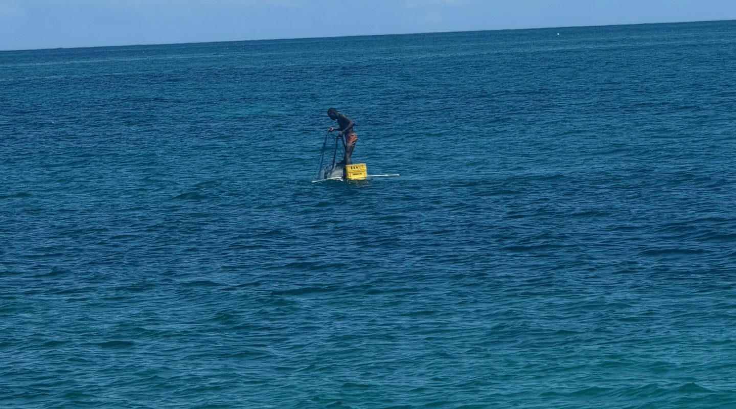 A fisherman standing on his raft off the north coast of Jamaica