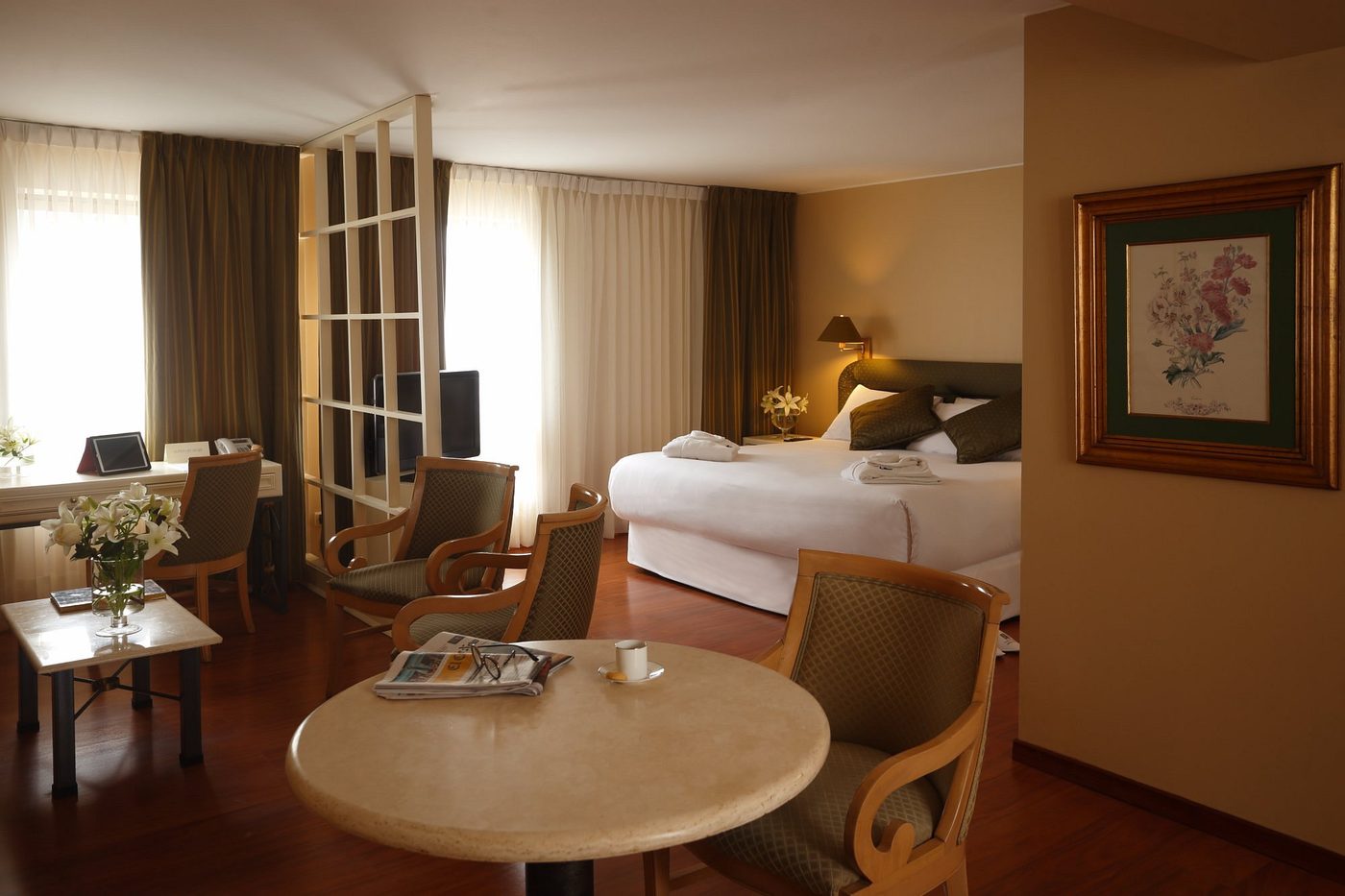 A suite with its sitting area and king bed
