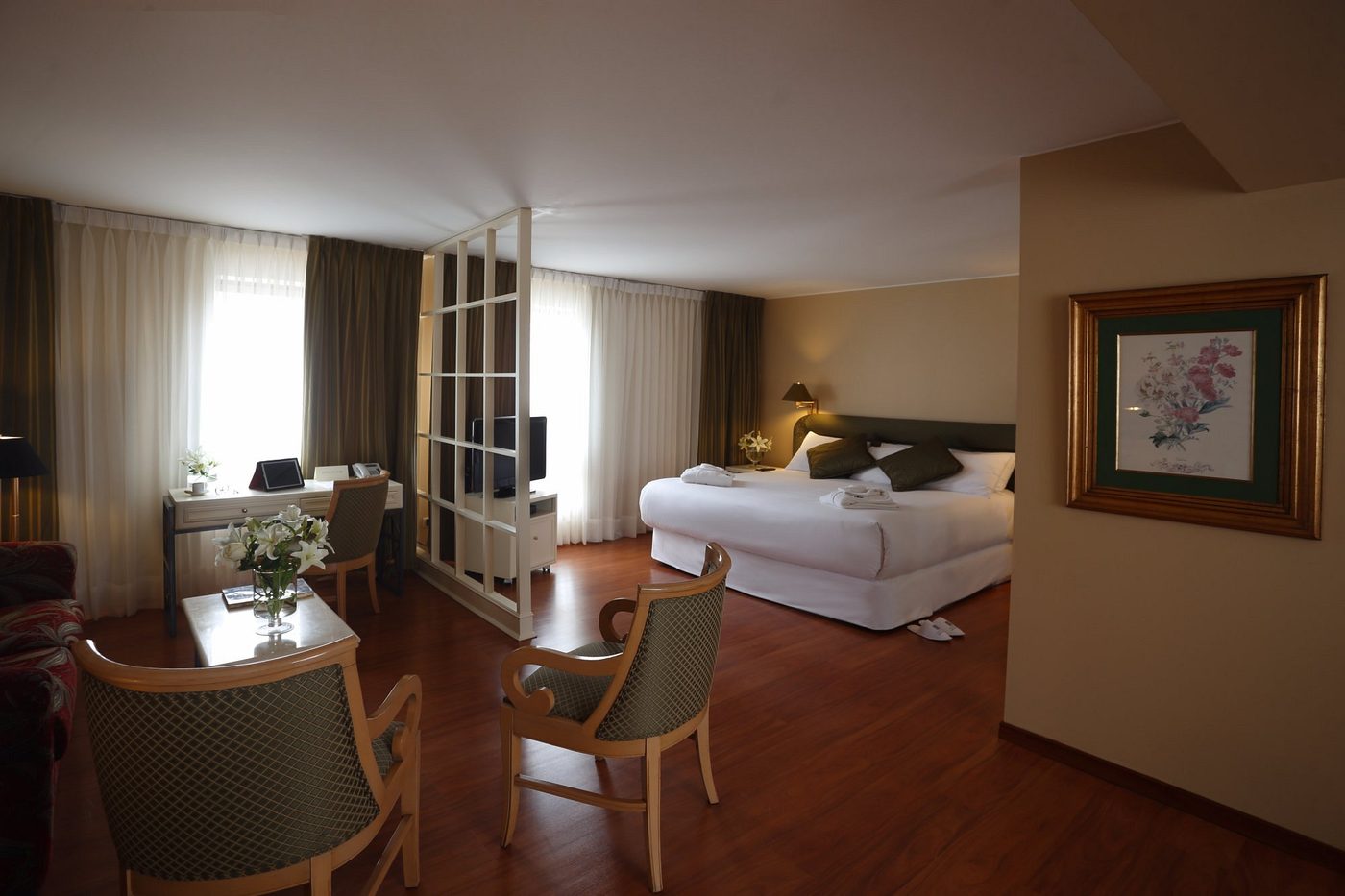 The suite living area, desk and bed