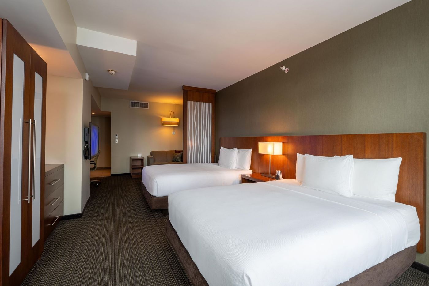 A room with two queen beds