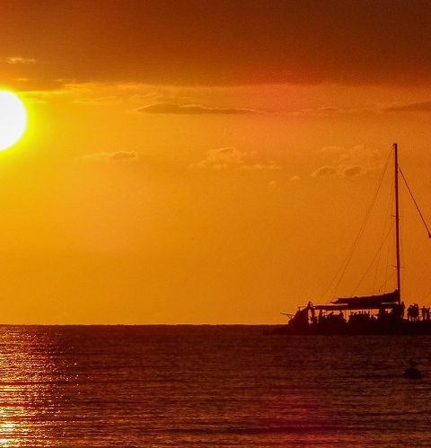 A catamaran at sunset off the coast of Jamaica